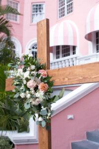 Wooden Cross with Pink Floral Detail and Greenery Wedding Décor | The Don CeSar Florida Wedding Venue