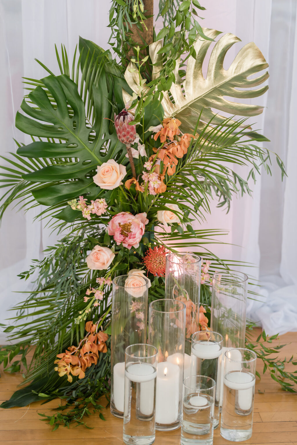 Elegant Tropical Wedding Floral Decor, Gold Painted Monstera Leaves, Palm Fronds, Pink Roses, Pin Cushion Protea, Pink Ginger, Orange Flowers, Floating Candles | Tampa Bay Wedding Planner Eventfull Weddings