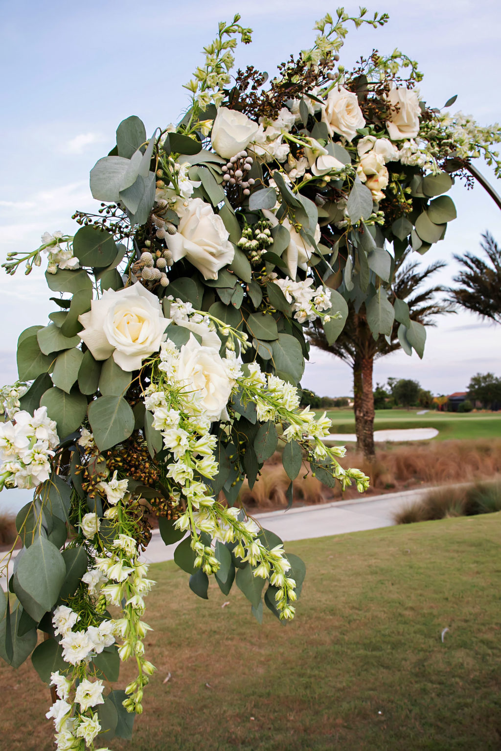 Romantic Floral Arrangement on Circular Metal arch, White and Ivory Roses, Eucalyptus, Greenery | Tampa Bay Wedding Photographer Limelight Photography | Wedding Florist Beneva Florals | Wedding Planner MDP Events