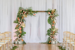 Tropical Elegant Wedding Ceremony Decor, Tropical Arch with Palm Fronts, Gold Painted Monstera Leaves, Pink Ginger, Pink Anthuriums and Orange Flowers, Floating Candles, Gold Vintage Chairs, White Linen Draping Backdrop | Tampa Bay Wedding Planner Eventfull Weddings | Wedding Linen Rentals Gabro Event Services | Wedding Chair Rentals A Chair Affair