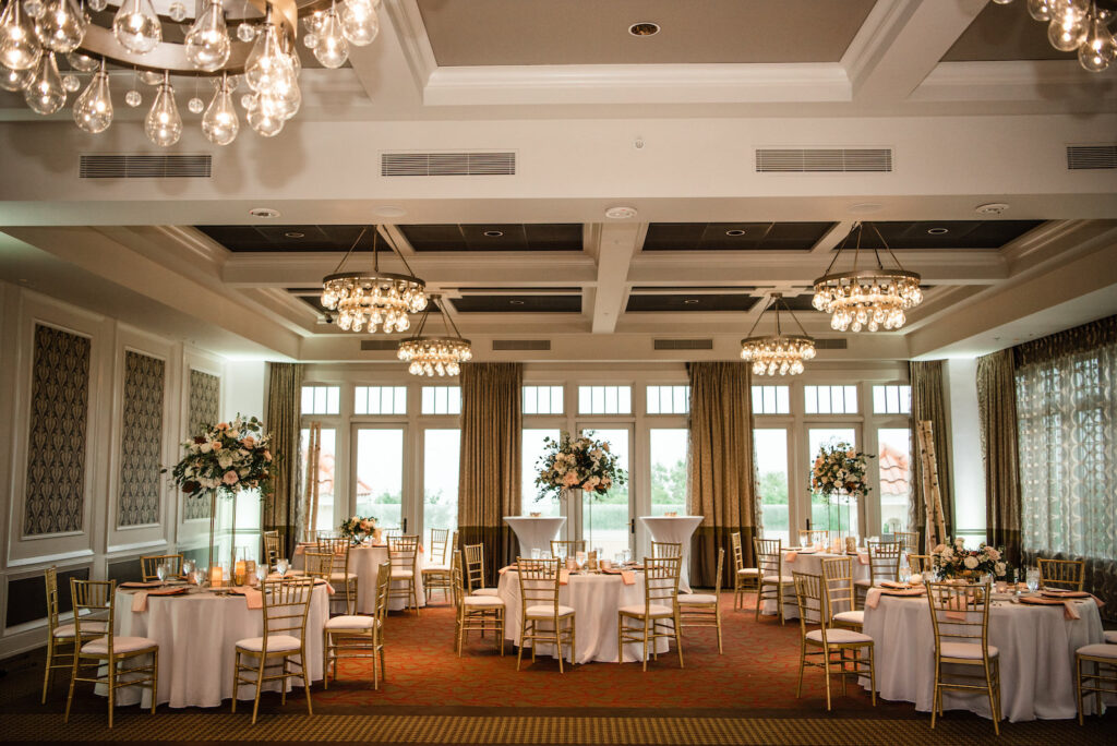 Romantic Wedding Reception Ballroom with Chandeliers, Gold Chiavari Chairs and Tall White and Pastel Pink Rose Centerpieces | St. Pete Rentals Gabro Event Services | Venue The Birchwood | Planner Perfecting the Plan
