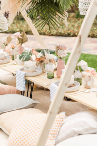 Boho Mid-Century Modern Wedding Decor, Natural Wood Low Picnic Table, Pillow Seating, Small Vases with Single Flowers and Dried Leaves | Tampa Bay Feasting Table Design Something Blue Orlando | Table Rental Kate Ryan Event Rentals | Big Fake Wedding Tampa