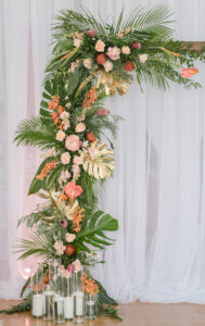 Tropical Elegant Wedding Ceremony Decor, Tropical Arch with Palm Fronts, Gold Painted Monstera Leaves, Pink Ginger, Pink Anthuriums and Orange Flowers, Floating Candles, Gold Vintage Chairs, White Linen Draping Backdrop | Tampa Bay Wedding Planner Eventfull Weddings | Wedding Linen Rentals Gabro Event Services