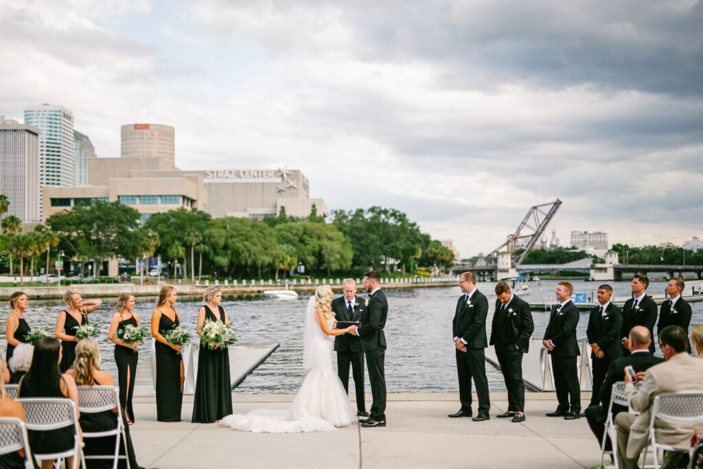 Florida Modern Elegant Bride and Groom Exchanging Wedding Vows During Waterfront Wedding Ceremony | Wedding Venue Tampa River Center