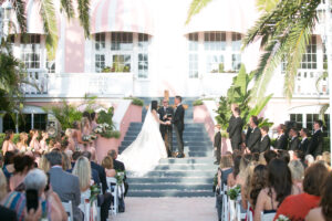 Bride and Groom Exchange Vows in Outdoor St. Pete Courtyard Wedding Ceremony | The Don CeSar | Photographer Carrie Wildes Photography