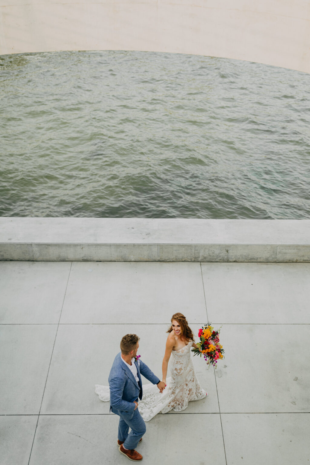 Florida Bride and Groom Holding Hands Waterfront From Above Wedding Photo | Tampa Bay Wedding Photographer Amber McWhorter Photography