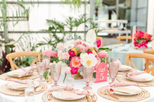 Boho Mid-Century Modern Wedding Reception Decor, Wicker Chargers, Blush Pink Linen Napkins, Vintage Pink Glassware, Colorful Yellow Pin Cushion Protea, King Protea, White Calla Lily, White and Pink Flower Low Centerpiece, Pink Acrylic Table Number, Wooden Cross Back Chairs | Table Design Boho Floral | Tampa Table and Chair Rentals Kate Ryan Event Rentals | Big Fake Wedding Tampa