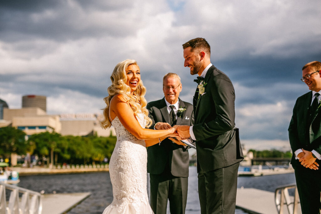 Florida Modern Elegant Bride and Groom Exchanging Wedding Vows During Waterfront Wedding Ceremony | Wedding Venue Tampa River Center
