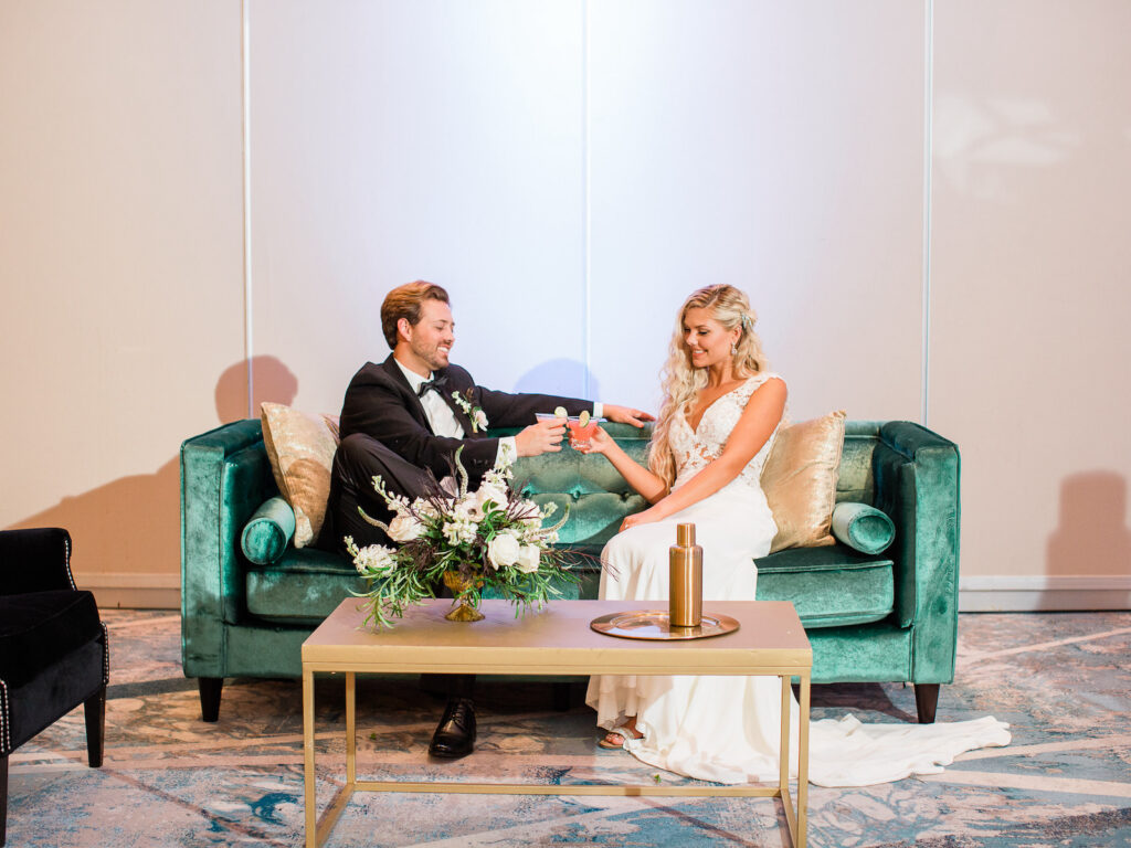 Bride and Groom Toasting on Wedding Loveseat Capture | Hilton Downtown Tampa