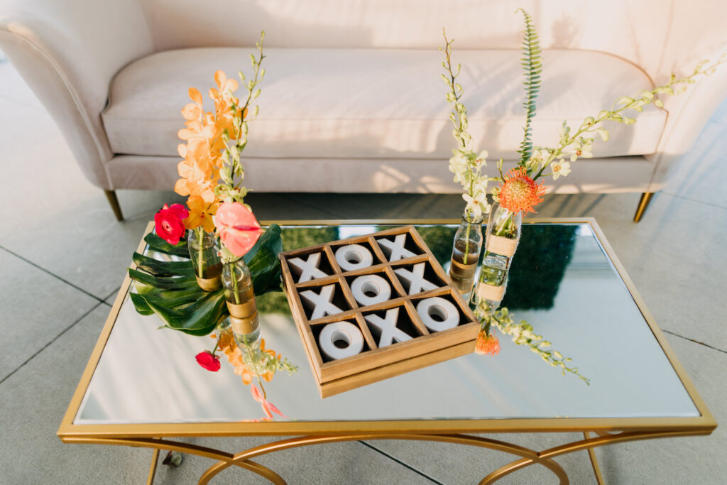 Tropical Boho Wedding Lounge Decor, Gold and Mirror Coffee Table, Tic Tac Toe Game, Single Flowers in Vases | Tampa Bay Wedding Photographer Amber McWhorter Photography | Wedding Rentals Kate Ryan Event Rentals
