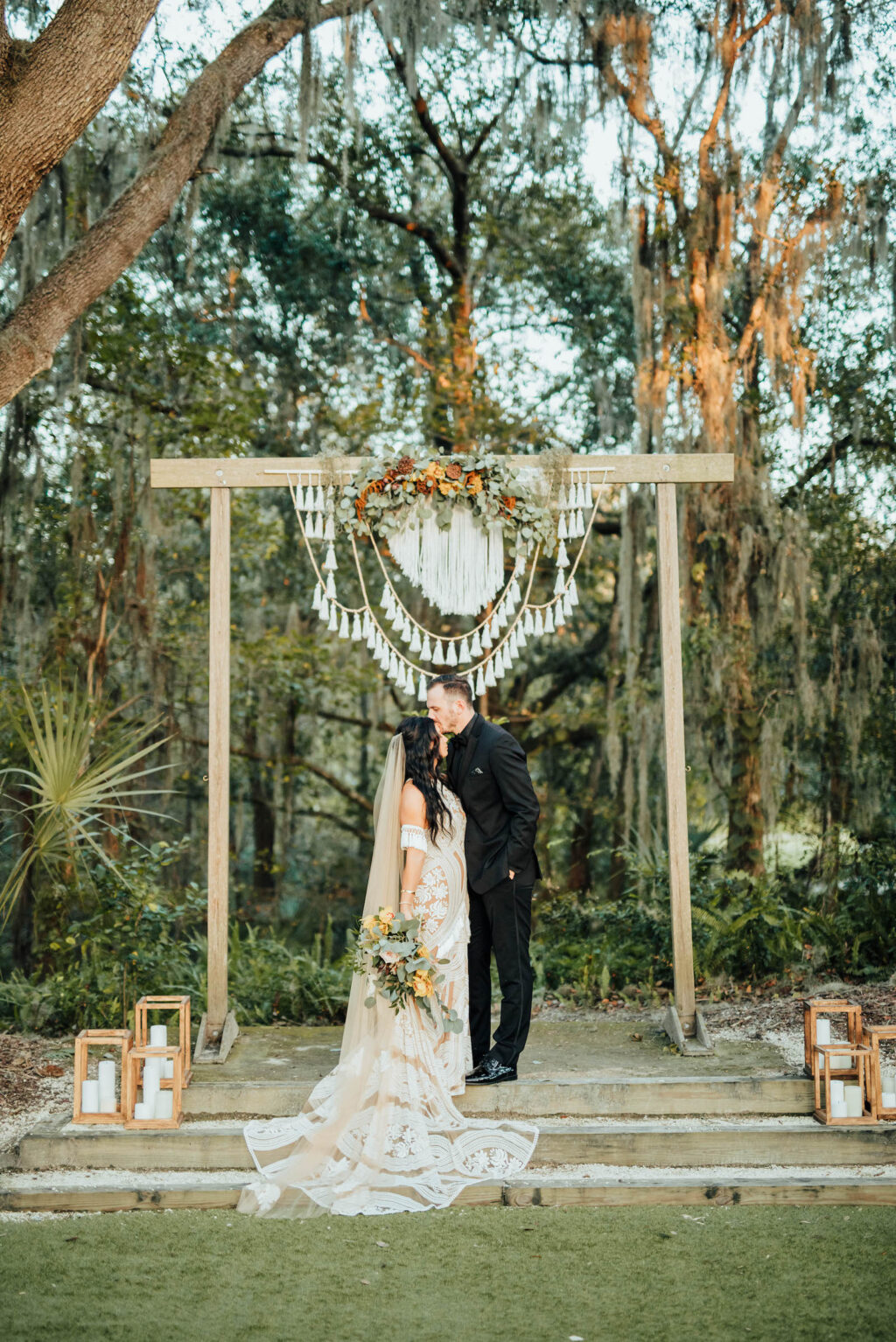 Bride and Groom Portrait | Outdoor Bohemian Wedding Ceremony with White Garden Chairs | Wooden Arch with Macrame Crochet Decor | Tampa Wedding Venue Paradise Springs