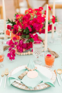 Boho Mid-Century Modern Wedding Reception Decor, White and Wooden Charger, Mint Green Linen Napkin, Vintage Clear Wine Glass, Fuschia Pink Flower Centerpiece, Candlesticks, White and Gold Flatware | Florida Wedding Planner Taylored Affairs | Big Fake Wedding Tampa
