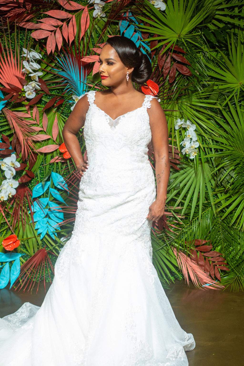 Dearly Beloved Fashion Show, Bride Wearing Fitted Mermaid Wedding Dress wtih Lace Straps, Fit and Flare Gown by Royal Bridal, Modern Tropical Floral Wall with Green, Pink and Aqua Blue | Florida Wedding Venue 7th and Grove