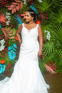 Dearly Beloved Fashion Show, Bride Wearing Fitted Mermaid Wedding Dress wtih Lace Straps, Fit and Flare Gown by Royal Bridal, Modern Tropical Floral Wall with Green, Pink and Aqua Blue | Florida Wedding Venue 7th and Grove