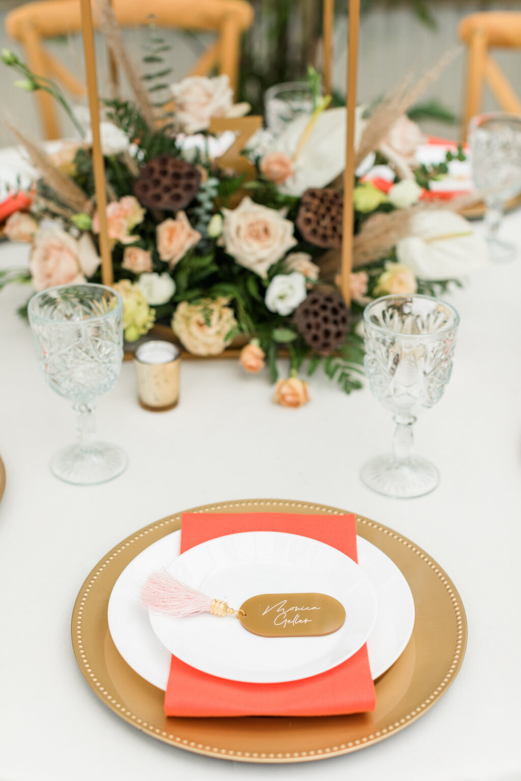 Boho Mid-Century Modern Wedding Decor, Gold Charger, Orange Linen Napkin, Gold Acrylic Place Card with Pink Tassle Ivory Roses, Greenery, Lotus Flower Seed Pod | Table Design Becca's Bloomin' Buds | Big Fake Wedding Tampa
