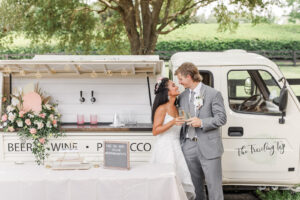 Boho Mid-Century Modern Bride and Groom Cheering Champagne Outside Mobile Bar The Traveling Tap | Florida Wedding Venue Mision Lago Estates | Big Fake Wedding Tampa