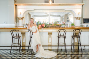 Florida Bride Wearing Vintage Strapless Wedding Dress Sitting at Bar | Historic Tampa Wedding Venue The Cuban Club | Adore Bridal Hair and Makeup