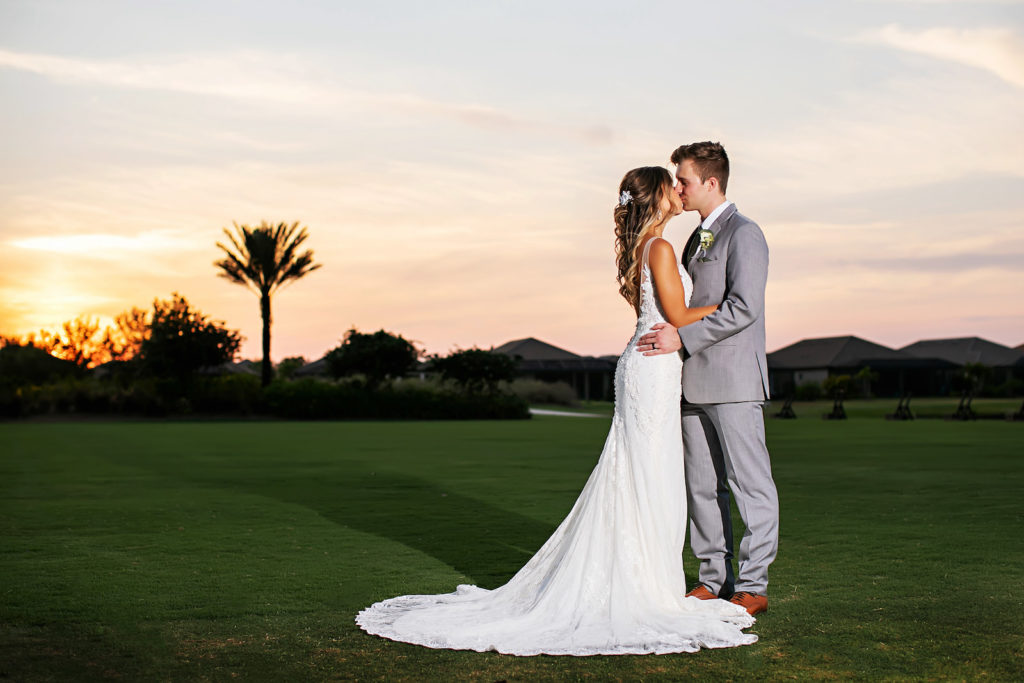 Bride and Groom Sunset Romantic Photo on Golf Course | Tampa Bay Wedding Photographer Limelight Photography | Wedding Venue Esplanade Country Club | Wedding Dress Truly Forever Bridal Sarasota | Wedding Hair and Makeup Adore Bridal