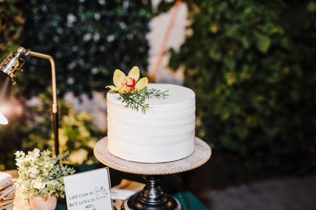 One Tier White Wedding Cake with Yellow Flower and Greenery