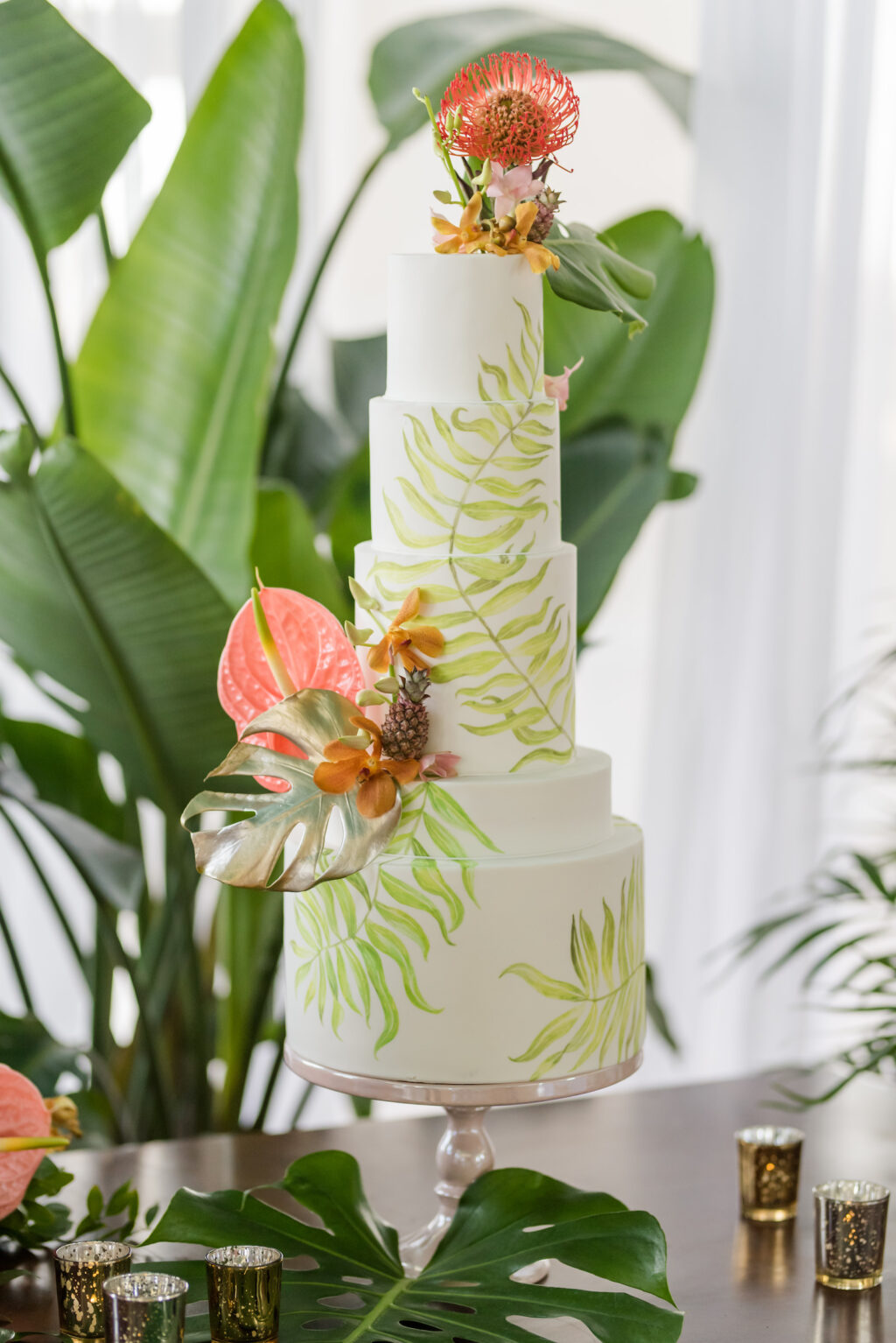 Five Tier White and Green Palm Leave Painted Wedding Cake Decorated with Pink Anthurium, Gold Painted Monstera Leaf, Mini Pineapple, Pink Pin Cushion Flower Cake Topper | Tampa Bay Wedding Planner Eventfull Weddings