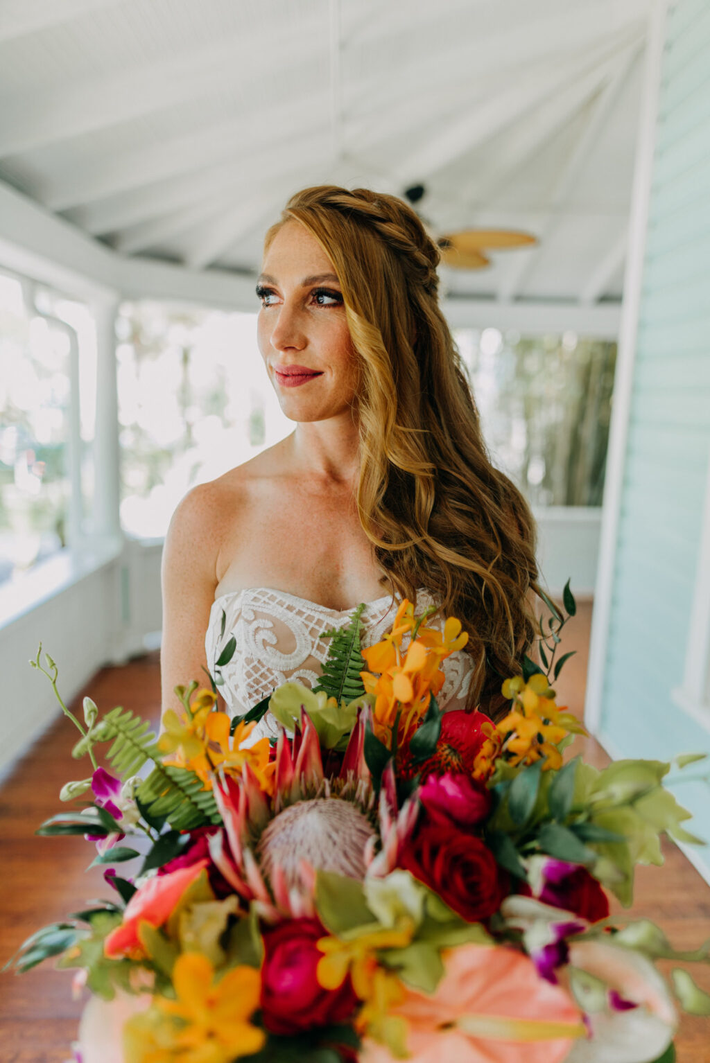 Tropical Boho Bride Holding Colorful Floral Bouqouet with King Protea and Pink Anthurium | Tampa Bay Wedding Photographer Amber McWhorter Photography | Wedding Hair and Makeup Femme Akoi Beauty Studio