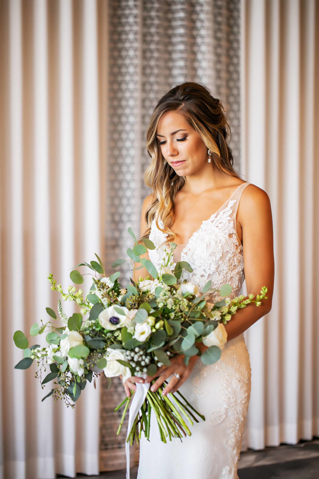 Romantic Bride Wearing Fitted Lace V Neckline Wedding Dress Holding White Anemone and Roses, Greenery and Eucalyptus Floral Bouquet | Tampa Bay Wedding Photographer Limelight Photography | Wedding Hair and Makeup Adore Bridal | Wedding Dress Truly Forever Bridal Sarasota | Wedding Florist Beneva Florals | Styled Shoot