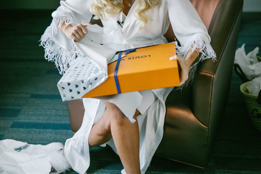 Florida Bride Wearing White and Feather Silk Robe Opening Louis Vuitton Present from Groom