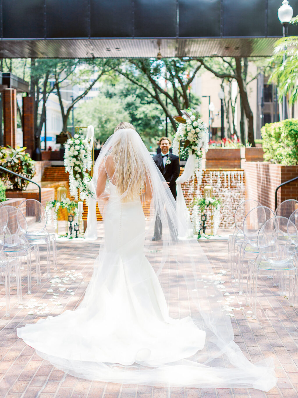 Groom Sees Bride for the First Time Walking Down the Aisle in Fit and Flare Wedding Gown Portrait | Truly Forever Bridal