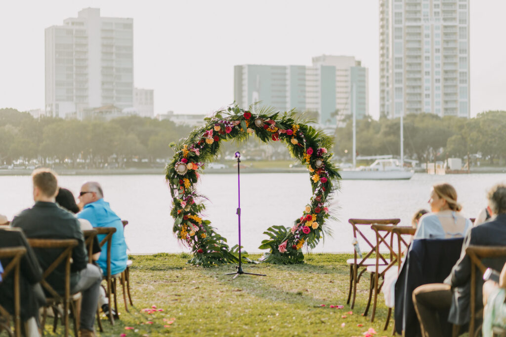 Waterfront Tropical Wedding Ceremony Decor, Circular Colorful Floral Arch | Tampa Bay Wedding Photographer Amber McWhorter Photography