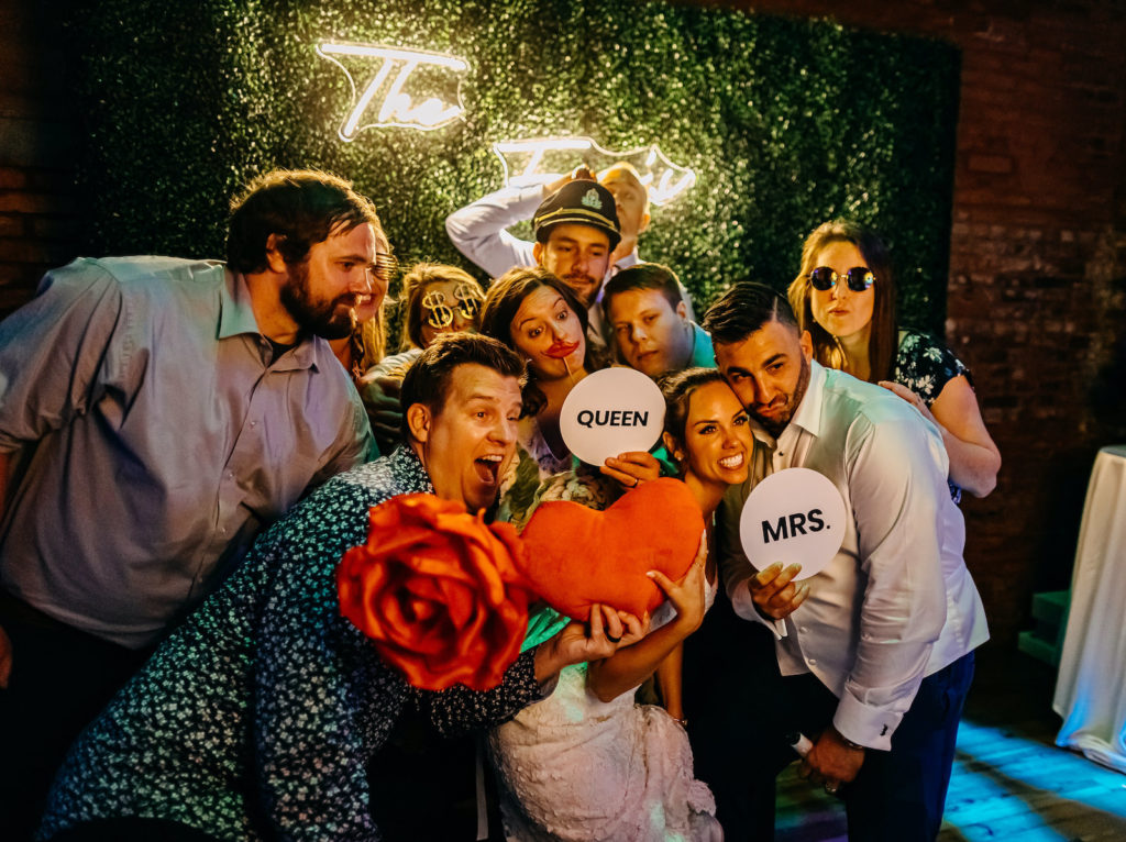 Open Air Photo Booth with Greenery Backdrop Wall and Neon Sign | Tampa Bay Luxury Rental Gala Photo Booth 