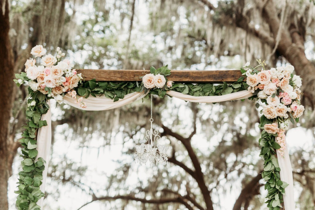 Rustic Wood Wedding Arch with Drapery and Floral Details