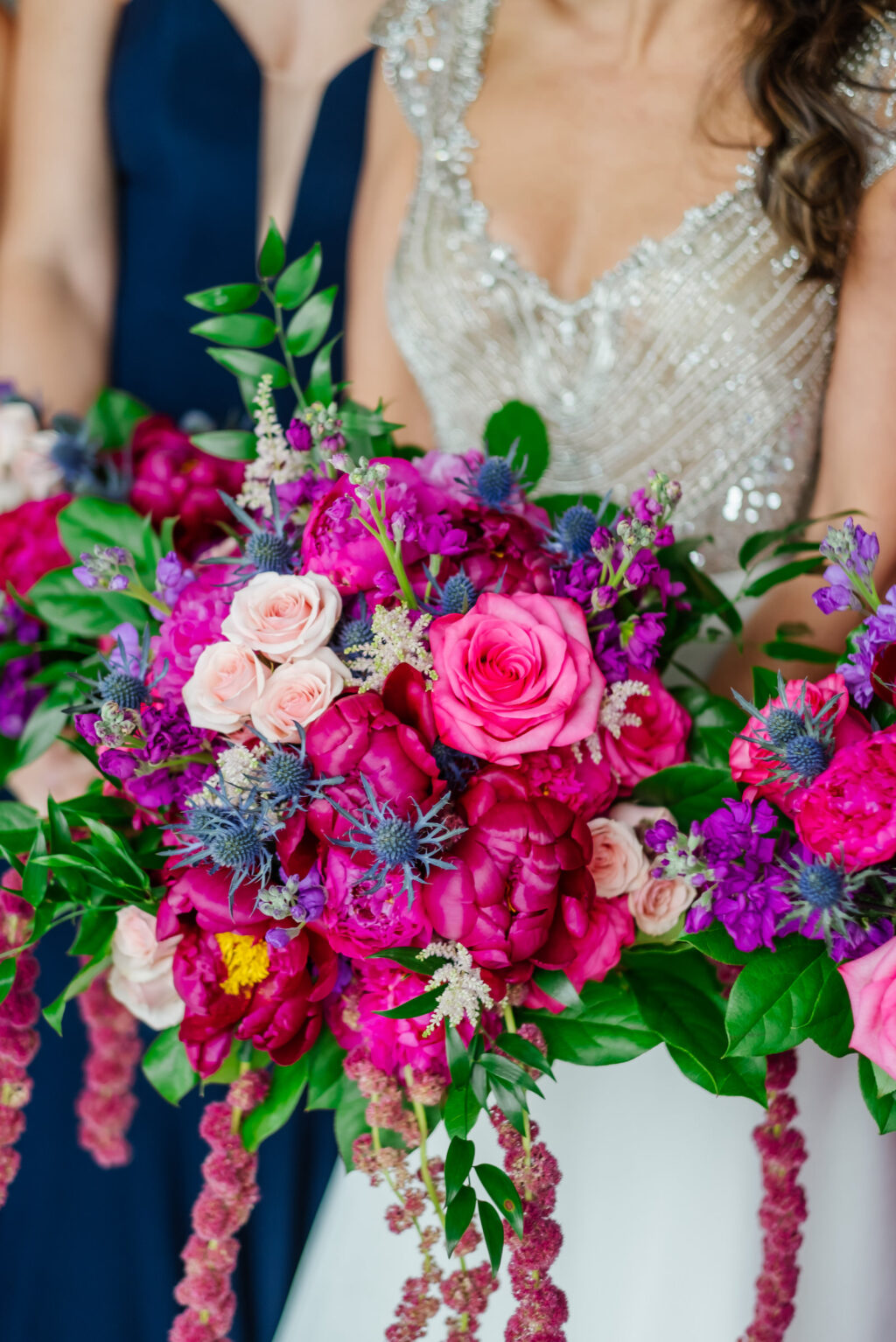 Bride Holding Jewel Tone Floral Bouquet, Pink and Fuschia Roses and Peonies, Purple Flowers, Thistle, Greenery Leaves, Hanging Amaranthus | Tampa Bay Wedding Florist Iza's Flowers