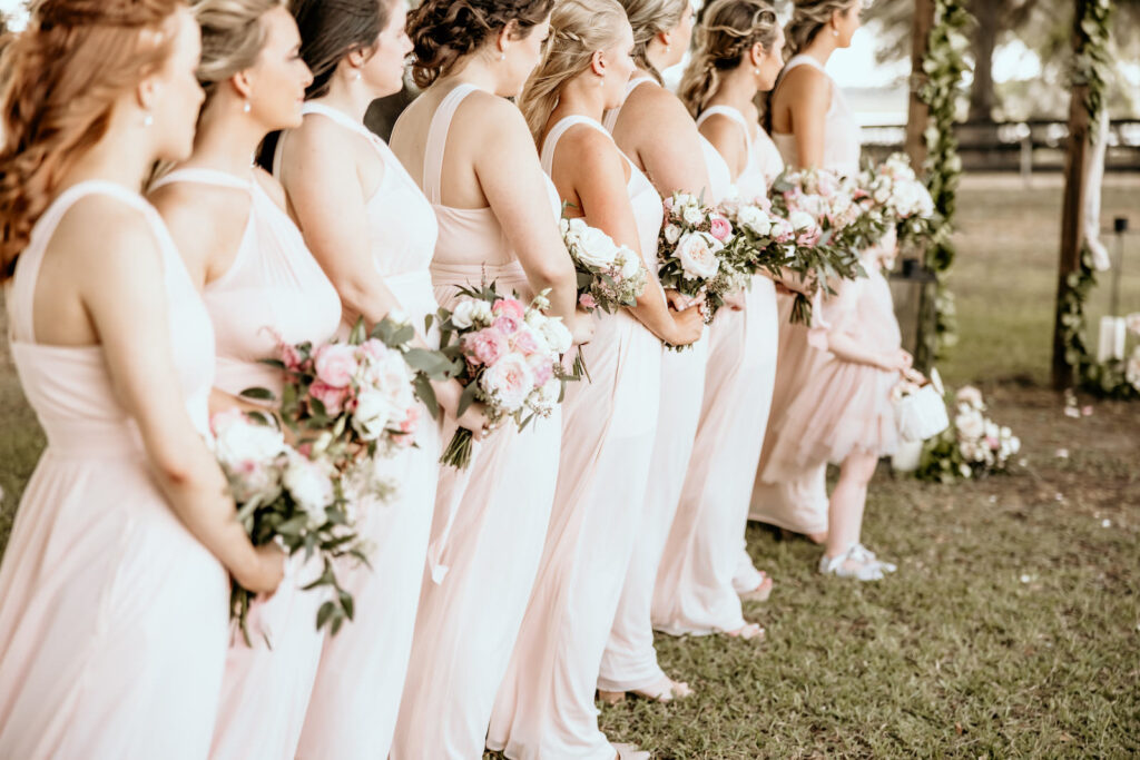Bridesmaids in Pale Pink Long Mix and Match Dresses and Pink and Greenery Floral Bouquets