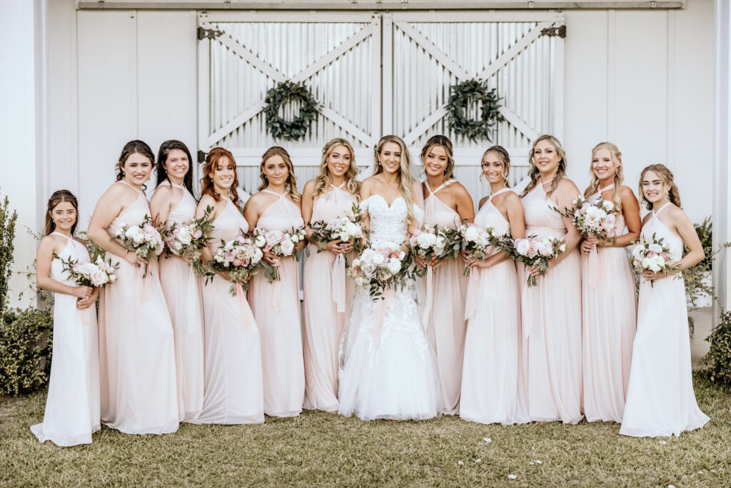 Bride and Bridal Party Wedding Portrait with Blush Pink Dresses and Greenery and Pale Pink Bouquets