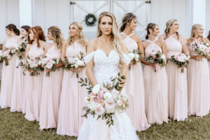Bride and Bridal Party Wedding Portrait with Blush Pink Dresses and Greenery and Pale Pink Bouquets