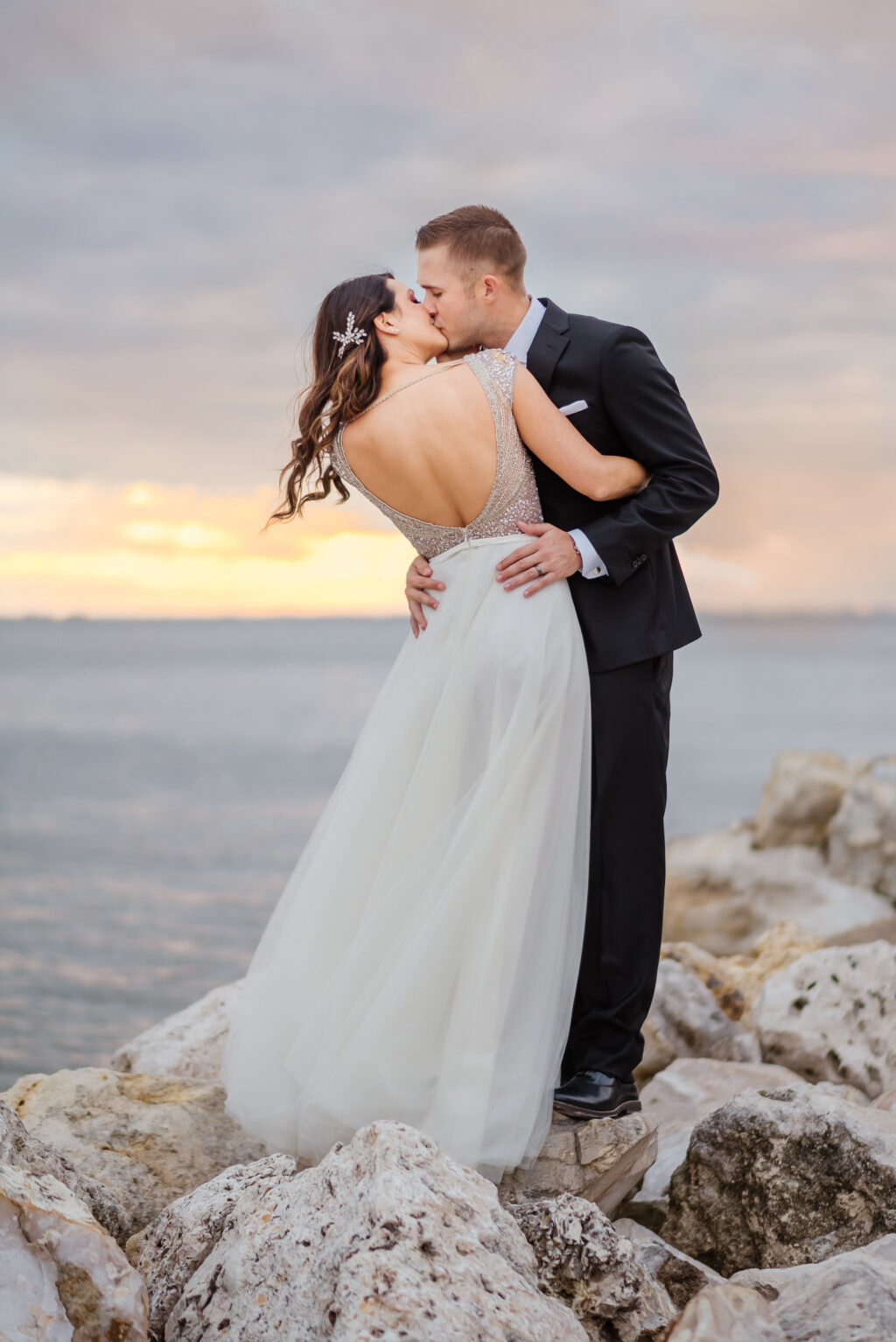 Sunset Bride and Groom Wedding Photo on Rocks on Tampa Beach