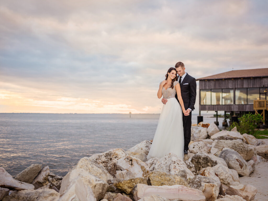 Sunset Bride and Groom Wedding Photo on Rocks on Tampa Beach