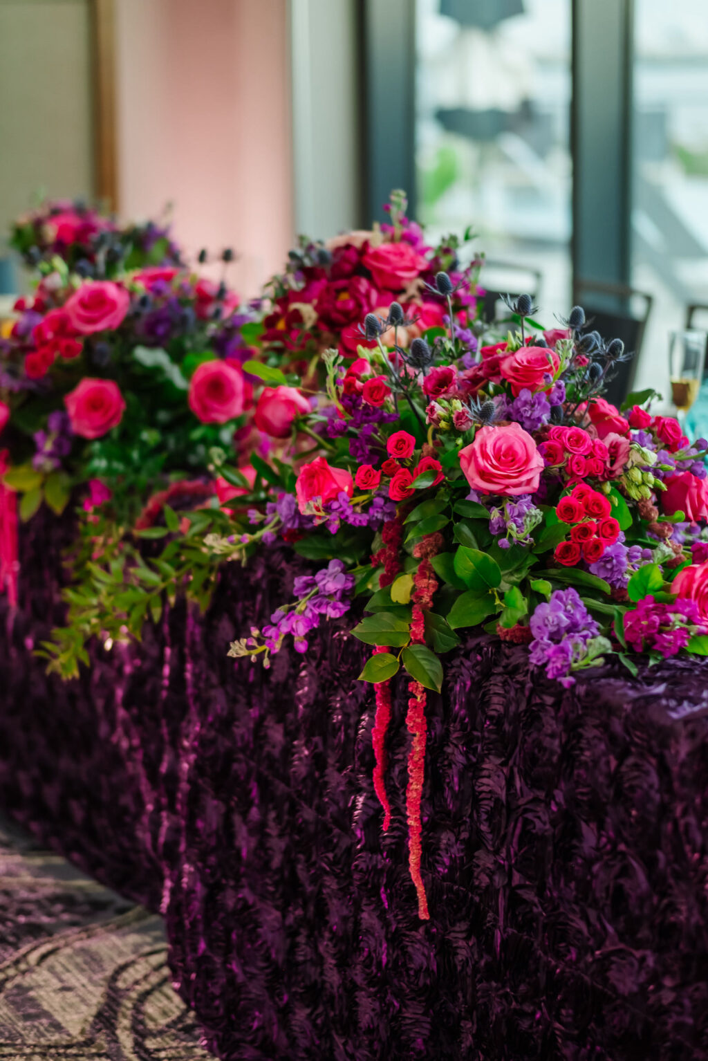 Jewel Tone Wedding Reception Decor, Long Table with Purple Linen, Pink Roses, Purple Flowers, Thistle, Hanging Amaranthus, Greenery Floral Arrangements | Tampa Bay Wedding Florist Iza's Flowers | Wedding Planner Perfecting the Plan
