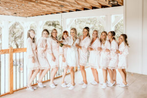 Bride and Bridesmaids in Pale Pink Silk Robes Wedding Portrait | Tampa Rustic Venue Covington Farms