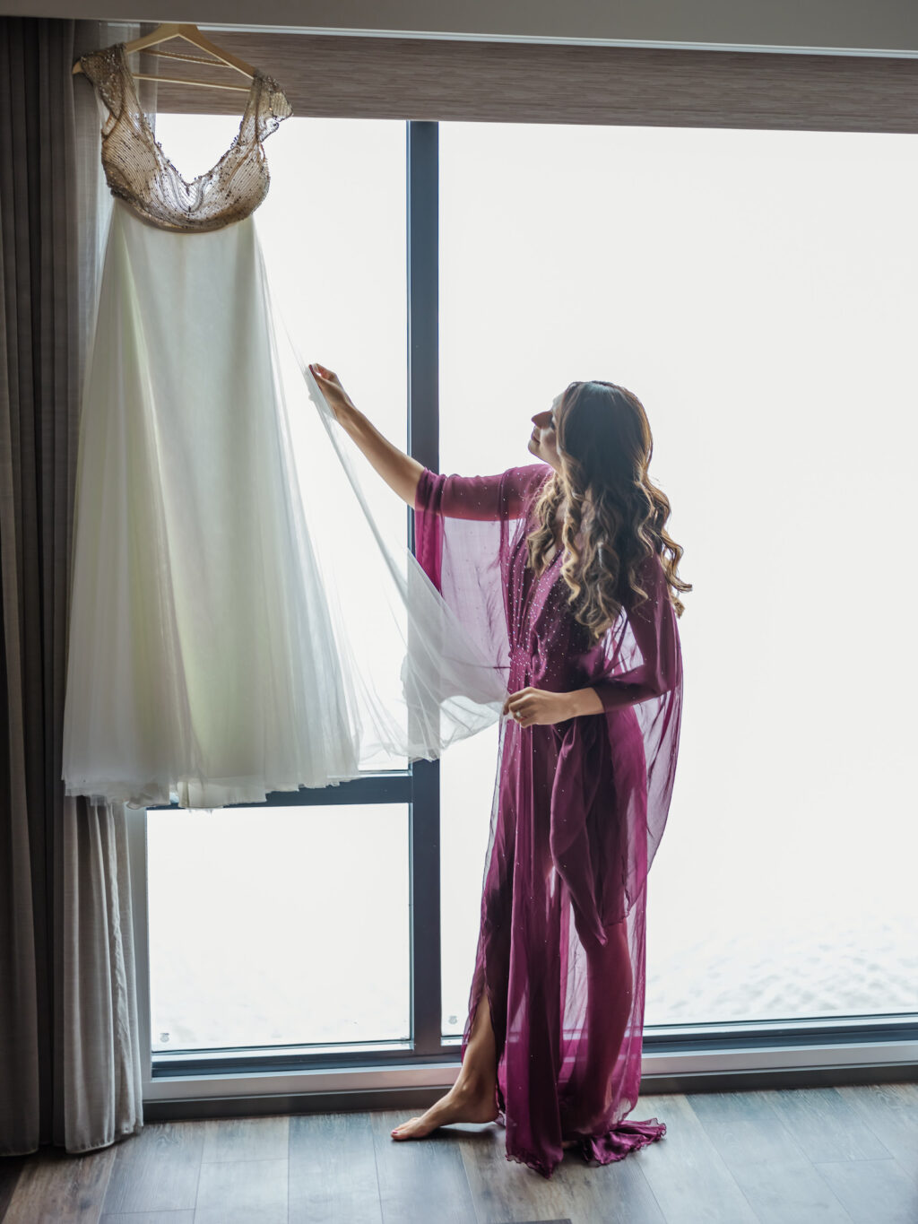 Tampa Bride Looking at Alon Livne Michelle Wedding Dress Getting Wedding Ready in Flowy Purple and Silver Polka Dot Robe