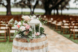 Barrel with Florals and Greenery on top with Lantern Rustic Wedding Décor | Florida Wedding Ceremony Covington Farms