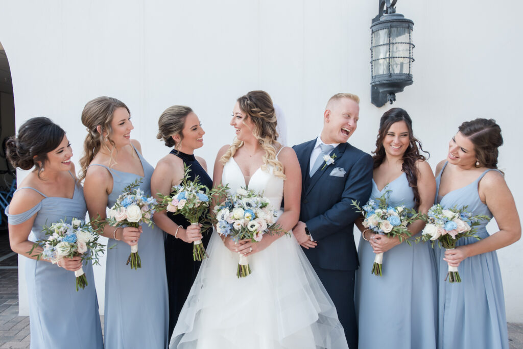 Bride and Bridal Party in Dusty Blue Long Dresses and Navy Tuxedo Wedding Portrait | Adore Bridal Hair & Makeup