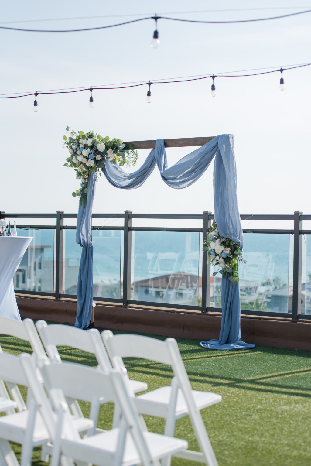 Wooden Ceremony Wedding Arch with Dusty Blue Draping | Rooftop St. Pete Beach Wedding Ceremony Hotel Zamora