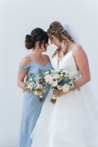 Maid of Honor in Dusty Blue Off the Shoulder Sweetheart Neckline Long Gown with Bride in Tulle Ballgown Wedding Portrait | Ashley Renee Bridal | Adore Bridal Hair & Makeup