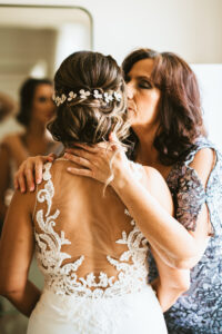 Florida with mom getting wedding ready, floral lace and illusion open back wedding dress, hair updo with flower crystal head piece | Tampa wedding photographer Bonnie Newman Creative | Wedding hair and makeup Femme Akoi