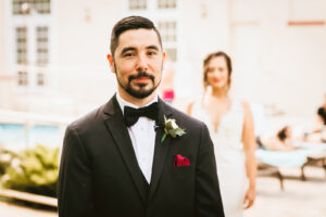 Florida groom waiting for first look with bride wearing black tuxedo and bow tie | Tampa Bay wedding photographer Bonnie Newman Creative