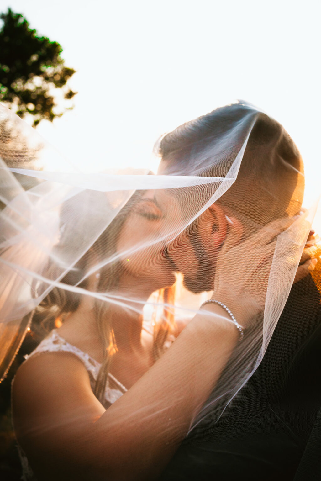 Florida waterfront bride and groom sunset veil wedding photo | Tampa wedding photographer Bonnie Newman Creative
