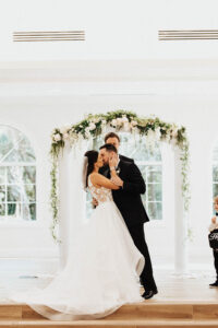 Bride and Groom First Kiss Portrait | Harborside Chapel Florida Wedding Ceremony