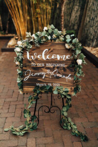 Wooden Wedding Sign with White Paint Lettering and Greenery