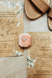 Diamond Engagement Ring in a Pink Velvet Box and Rustic Wedding Invitations